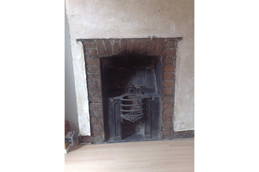 Uncovering old fireplace in bedroom