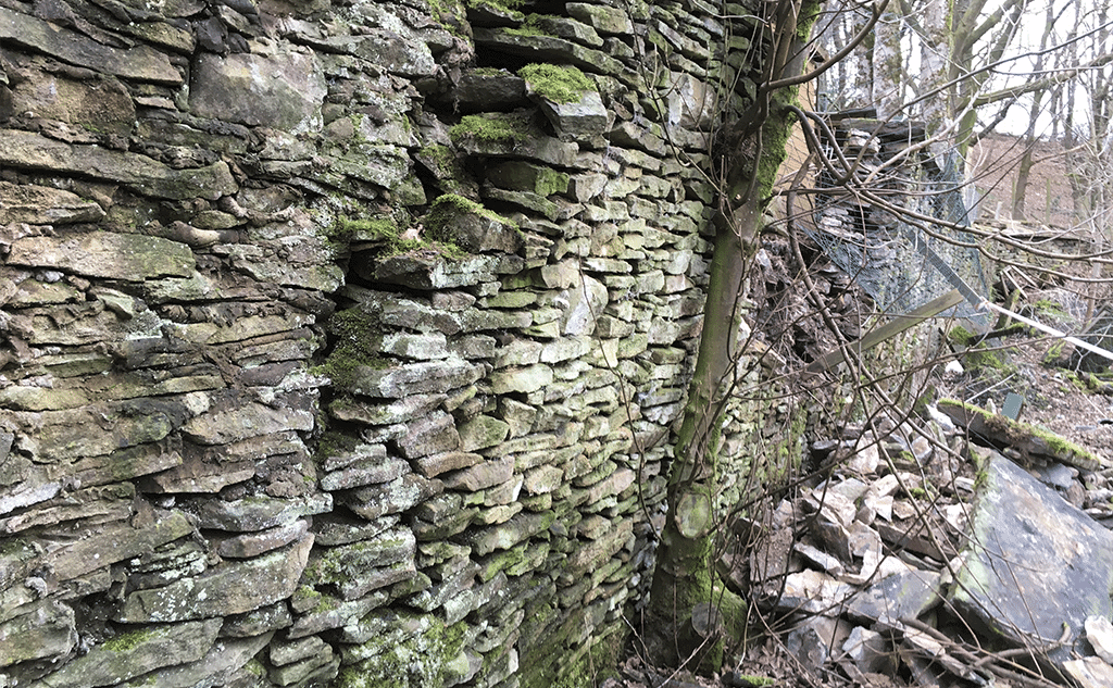 Collapsed lime mortar stone wall