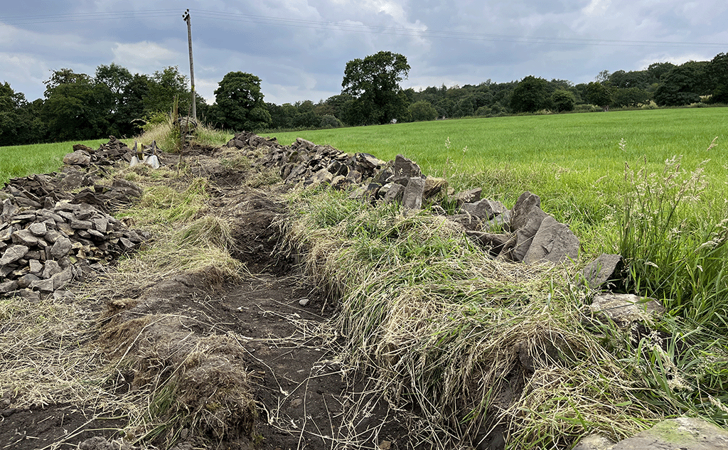 Groundworks for dry stone wall foundation trench
