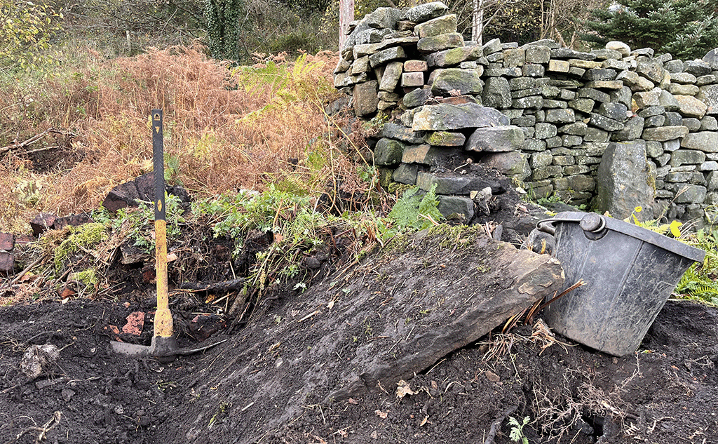 Stripping damaged dry stone wall in Littleborough
